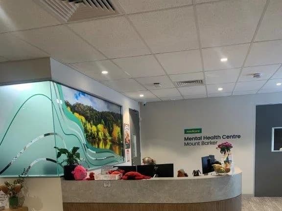 The reception of a completed health centre fit-out with recessed ceiling lighting and concealed lighting under the counter